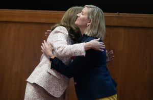 Photo of Dr. Townsend receiving a congratulatory hug from Dr. McQueen